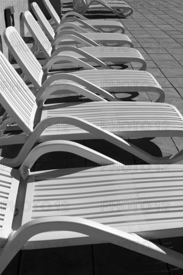 White resin solarium hammocks row black and white
