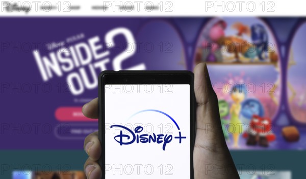 Smartphone with Disney+ logo displayed on the screen.