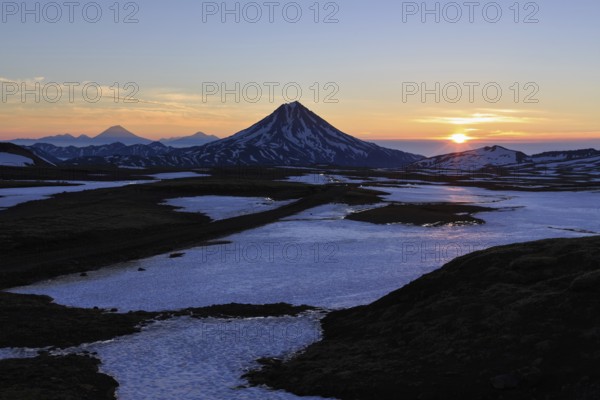 Volcanic landscape of Kamchatka Peninsula: beautiful sunrise over Viluchinsky Volcano. Asia, Russian Far East, Kamchatka Peninsula