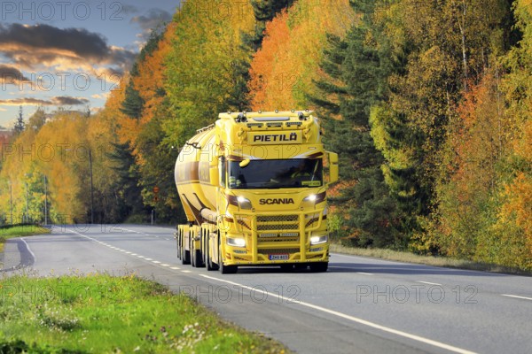 Beautifully customized yellow brown Nextgen Scania tank truck for bulk transport on Highway 10 on a day of autumn. Tammela, Finland. October 2, 2020