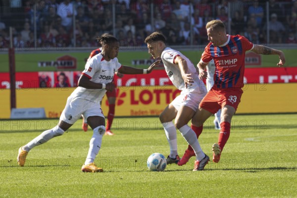 Football match, Junior ADAMU SC Freiburg and Maximilian EGGESTEIN SC Freiburg fighting for the ball with Lennard MALONEY 1.FC Heidenheim, football stadium Voith-Arena, Heidenheim