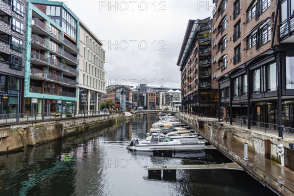 Oslo, Norway, August 10, 2019: New residential luxury buildings in Aker Brygge area a rainy day of summer. It is a popular area for shopping, dining and entertainment, as well as a high-end residential area, Europe
