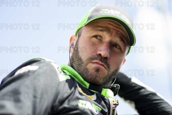 AGUSTIN HUGO CANAPINO (R) (78) of Arrecifes, Argentina suits up on pit road prior to practice for the HyVee Indycar Weekend at Iowa Speedway in Newtown IA