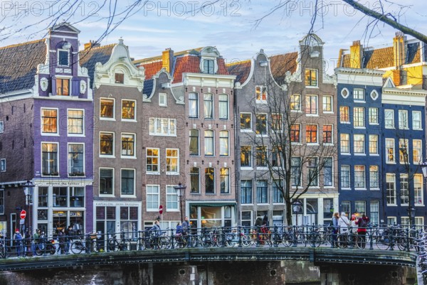 Beautiful dutch houses in Amsterdam city at sunset