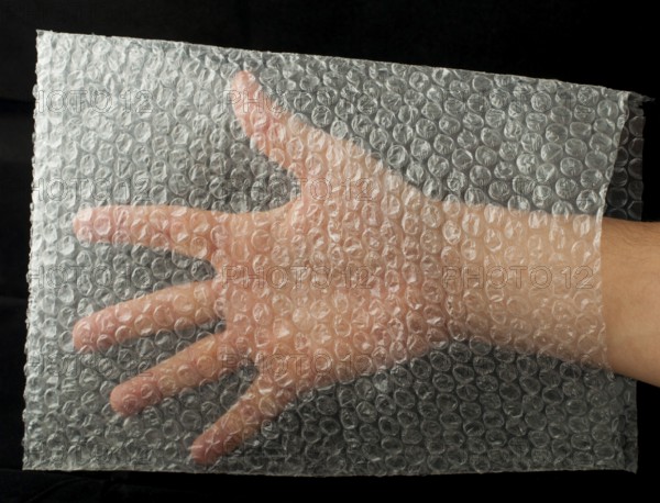 Plastic bag and hand inside. Black isolated