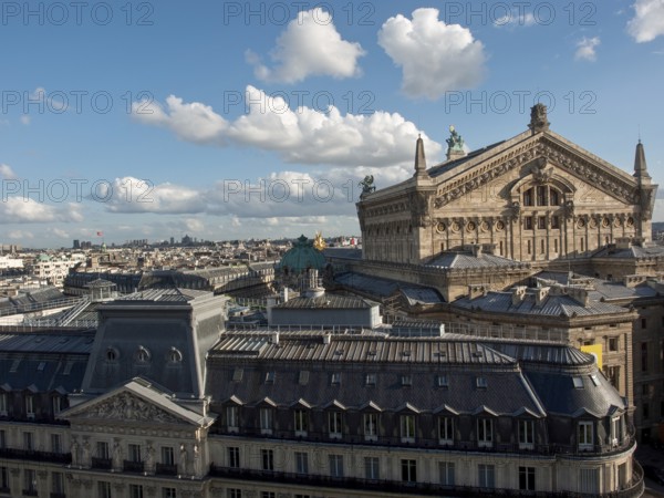 View over the roofs of a city with a high, richly decorated building, Paris, France, Europe
