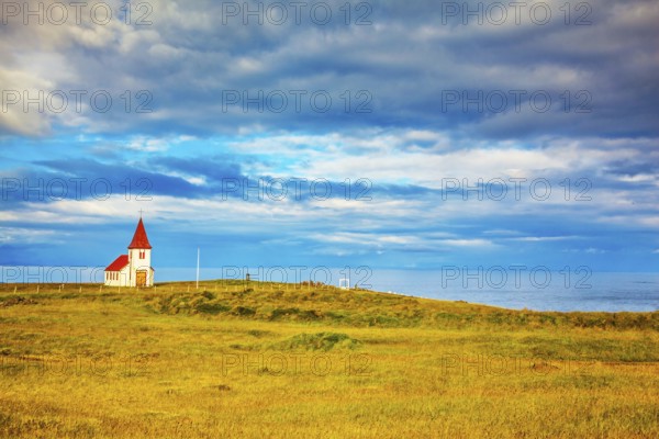 Iceland. White Chapel with red roof on the northern fjord