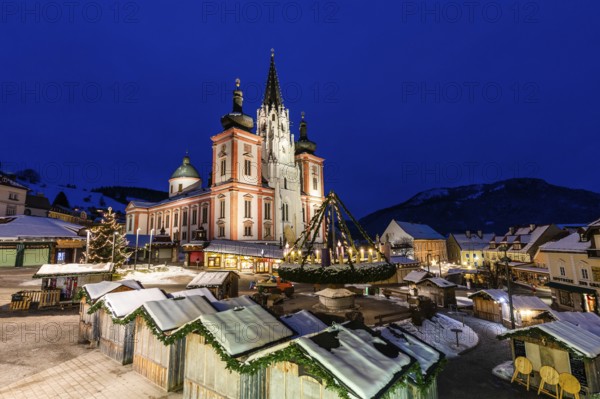 Advent atmosphere, world's largest hanging Advent wreath at the Christmas market in front of the basilica of Mariazell, blue hour in the early morning, Mariazell, Styria, Austria, Europe