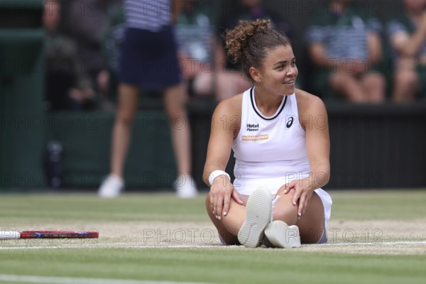 Italian tennis player Jasmine Paolini sitting on the ground after a fall at the 2024 Wimbledon Championships, London, England, United Kingdom, Europe