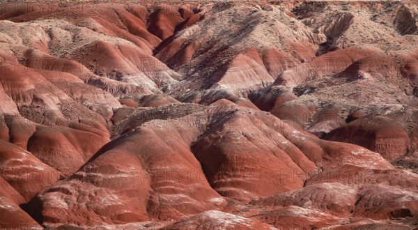 Red rock formations in a desert landscape showing erosion and barren hills in Arizona, USA, North America