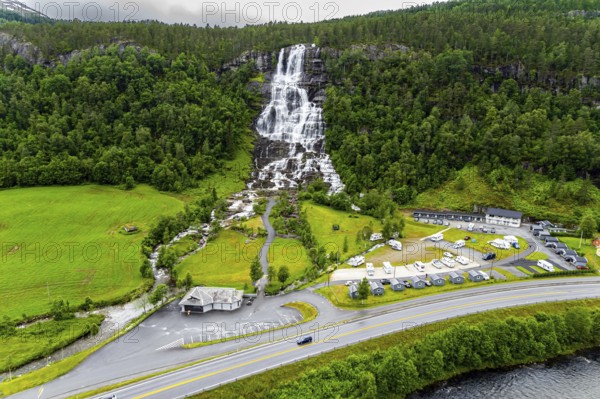 The colossal roaring waterfall Twindefossen. Rainy summer day in the mountains of Norway. Exciting adventure in the north of Norway. Travel north. The photo was taken from a drone