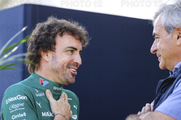 MELBOURNE, AUSTRALIA - MARCH 13: Fernando Alonso of Spain and Aston Martin Aramco F1 Team talks to Carlos Sainz Snr before the 2025 Australian Grand Prix at Albert Park in Melbourne, Australia, Oceania