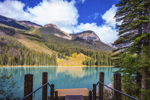 Magic Emerald Lake in Yoho National Park, Rocky Mountains. The descent to the water on the lake promenade. The concept of eco-tourism