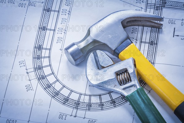 Claw hammer adjustable key on blueprint building and architecture concept