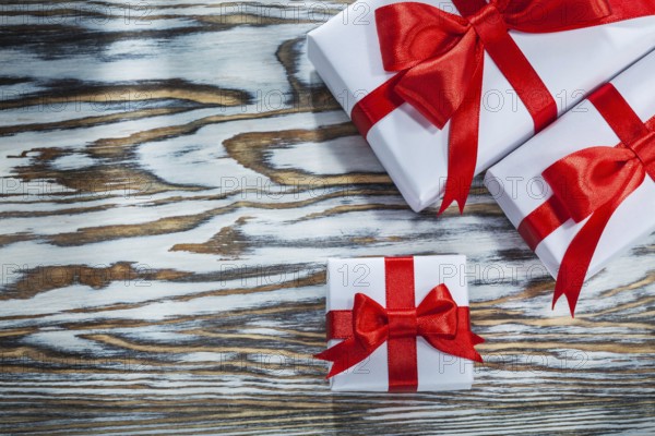 Red packed gift boxes on wooden surface