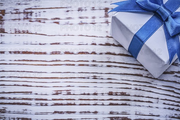 Wrapped present box on vintage wooden board holidays concept