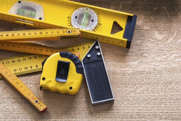Oaken board with wooden meter measuring line construction level and square ruler maintenance concept