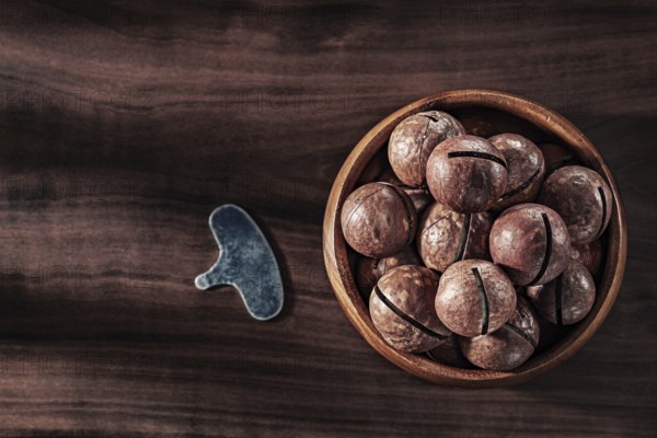 Macadamia Nuts In Wooden Bowl Key For Open On Vintage Wood