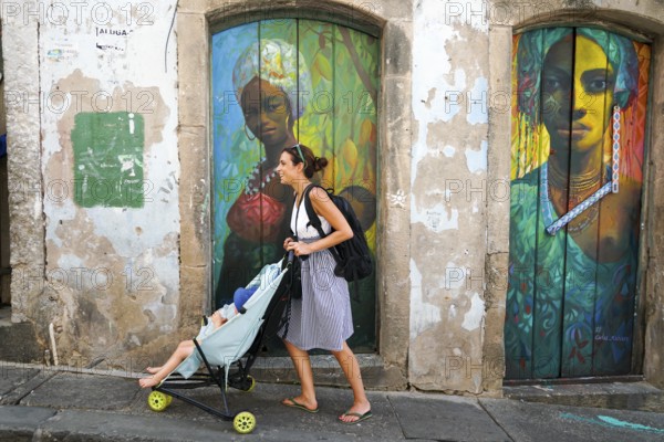 Tourist walking in the colorful historic district of Pelourinho, Bahia, Brazil. Historic neighborhood famous attraction for tourist sightseeing. February 11th, 2020