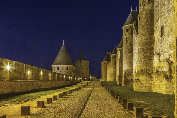 Cite de Carcassonne is a medieval citadel located in the French city of Carcassonne. Towers and wal in Evening