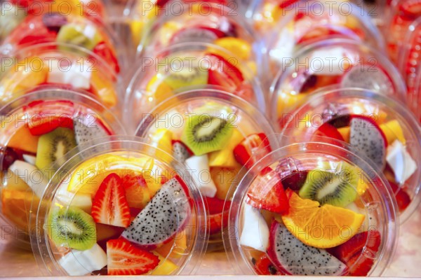 Colorful natural fruit salad transparent glasses in a row