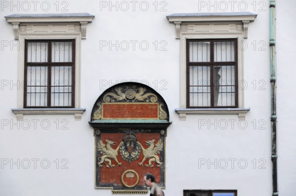 Historic building façade with two windows and a coat of arms, Vienna, Austria, Europe