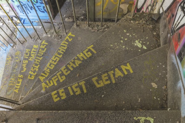 Graffiti-covered staircase with yellow text: Everything I had swallowed, slashed, hung up, it's done, railway depot Dortmund-Hafen, Lost Place, Dortmund, North Rhine-Westphalia, Germany, Europe