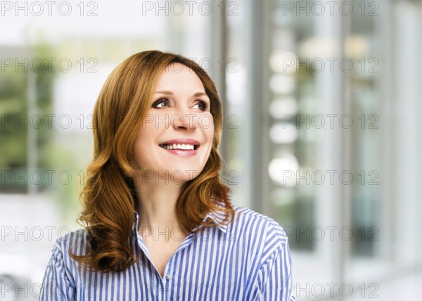 Smiling confident stylish mature middle aged woman at office. Senior businesswoman, executive business leader manager looking at camera arms crossed, portrait