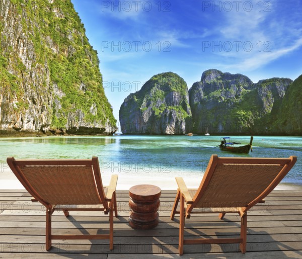 Charming lookout for two. Two convenient comfortable guest sun loungers and a bedside table are worth on a wooden platform. An excellent review on the beach and native boats