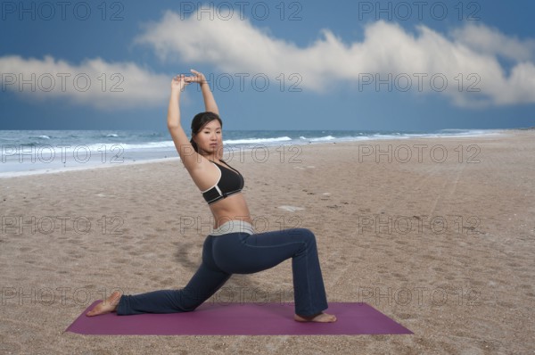 Beautiful Asian woman doing her Yoga execises