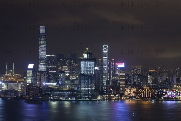 Symphony of Lights in night Hong Kong. Illuminated skyscrapers and colorful reflection in water from city lights
