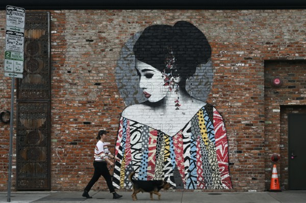 Passers-by in front of a mural on Selma Avenue, Hollywood, Los Angeles, California, USA, North America