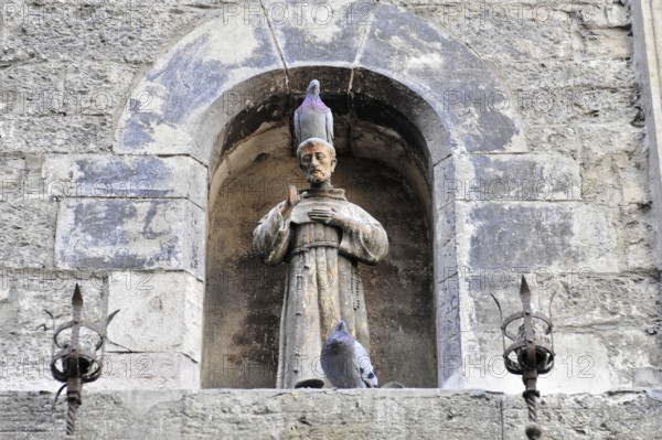Assisi, Umbria, Italy, Europe, stone altar with a statue of a saint in the niche, decorated with doves, conveys a calm and ancient atmosphere, Europe