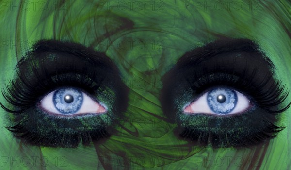 Abstract blue woman eyes makeup with a green texture skin