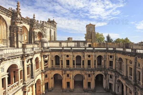 Courtyard, patio, surrounded by a gallery. The imposing medieval castle of the Knights Templar and the bell tower