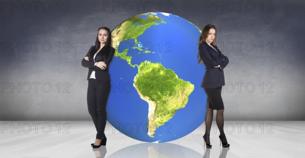 Business women stands near big earth ball in the gray room.Elements of this image furnished by NASA