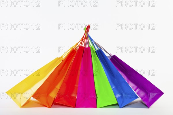 Set of colorful empty shopping bags isolated on the white background. Sale, consumerism, advertisement and retail concept. Many colorful shopping bags