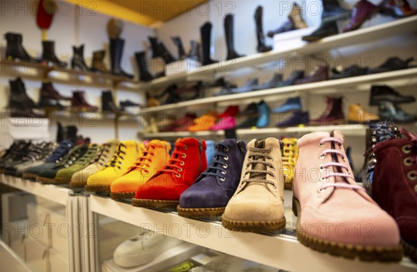 Colorful women boots/shoes are seen arranged