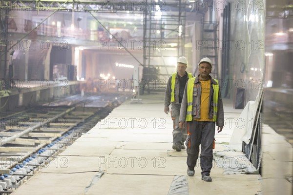 Sofia, Bulgaria - April 19, 2016: Two underground subway tunnel workers are going for lunch during their midday break