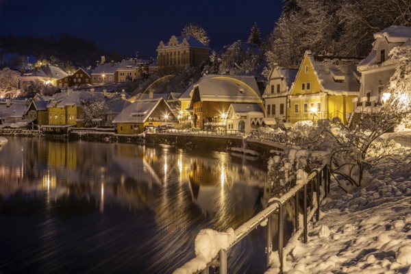 Winter view of Cesky Krumlov, picturesque houses under the castle with snow-covered roofs. Narrow streets and the Vltava river. Travel and Holiday in Europe. Christmas time. UNESCO World Heritage. Czech Republic