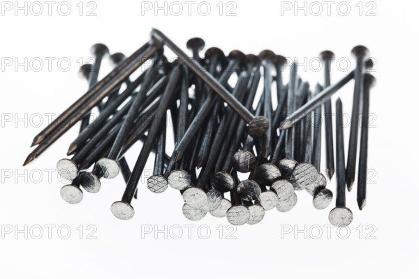 Nails of a craftsman on a building site lie on a white plate. Austria