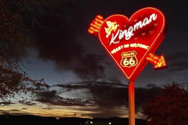 Kingman neon sign in front of a dramatic evening sky, Kingman, Arizona, USA, North America