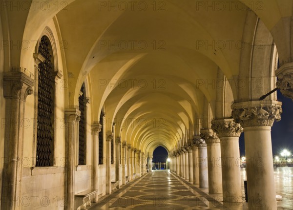 Illuminated archway of the Palazzo Ducale at night, Venice, Italy Venice, Italy, Europe