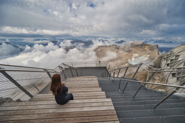 Alps mountain range view from Zugspitze Peak top of Germany with woman tourist, Garmisch Partenkirchen Germany