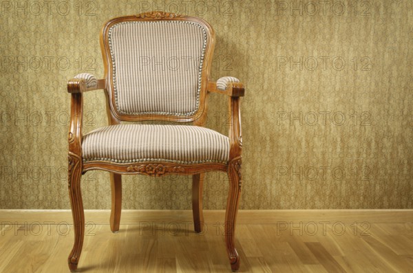 Single Old Antique Armchair Near The Wall