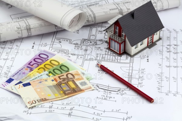 An architect's construction plan with euro money. Symbolic photo for financing and planning a new house