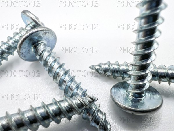 Metal screws on white background