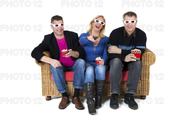 Three persons are laughing about the 3D movie on televison
