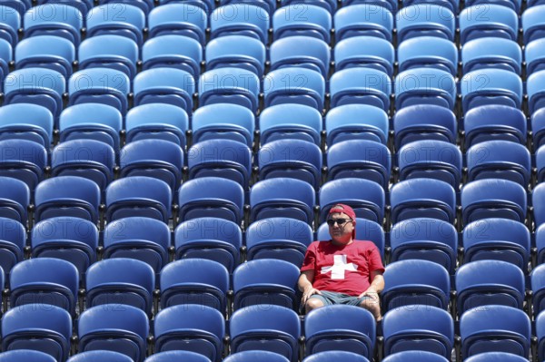 One single Swiss fan sitting in the stands watching the Australian Open 2025 junior boys singles final, Melbourne Park, Melbourne, Victoria, Australia, Oceania