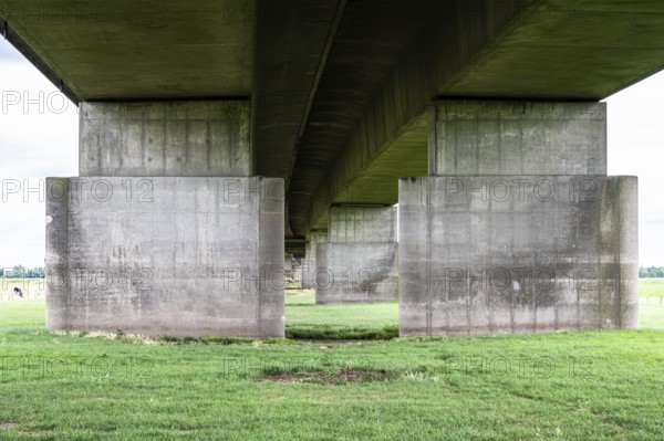 Tiel, Gelderland, The Netherlands, 07 14 2022, Concrete suspension bridge of the A15 highway surrounded by green meadows, Europe
